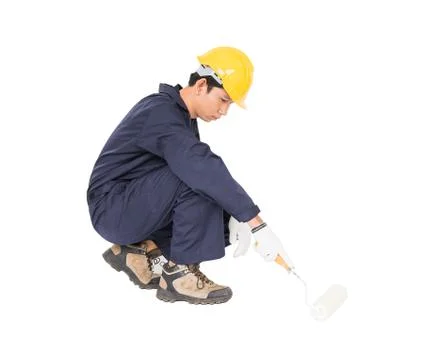 Worker in a uniform using a paint roller is painting invisible floor Stock Photos