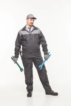 Worker in uniform with wrench Stock Photos
