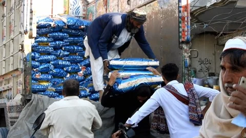 Worker Unloading Heavy Parcels From A Cargo Truck In Khushab Bazaar, Pakistan Stock Footage 227152692