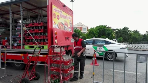 Worker Unloading Soft Drink Crates from Delivery Truck in Bangkok Stock Footage 343593747