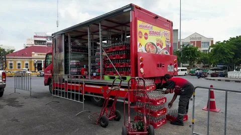 Worker Unloading Soft Drink Crates from Red Delivery Truck in Bangkok Stock Footage 344106124