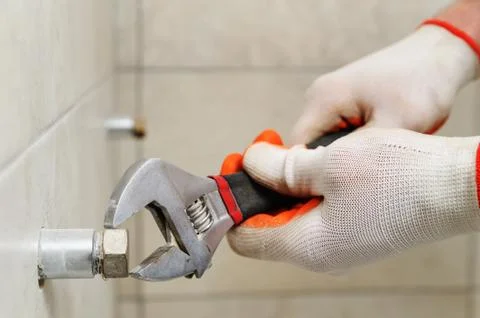 Worker unscrew the nut. Stock Photos