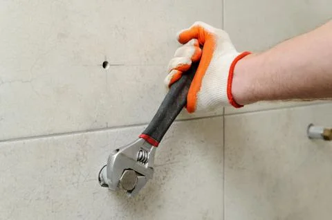 Worker unscrew the nut. Stock Photos