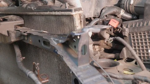 Worker unscrews engine coolant radiator of vehicle. Broken car after car Stock-Footage 121116964