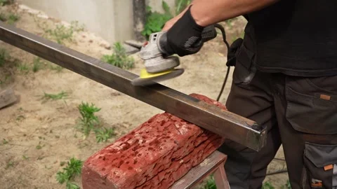 Worker use an Angle Grinder producing. Worker grinding metal Stock Footage 258645815