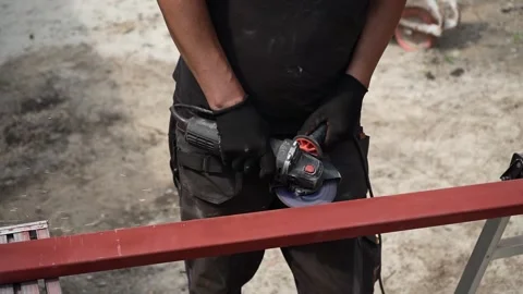 Worker use an Angle Grinder producing. Worker grinding metal Stock Footage 258645870