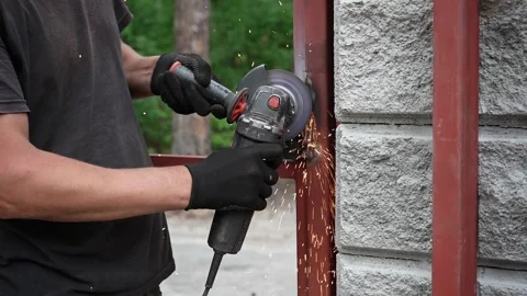 Worker use an Angle Grinder producing. Worker grinding metal Stock-Footage 258645885
