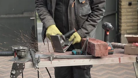 Worker use an Angle Grinder producing. Worker grinding meta Stock Footage 261173368