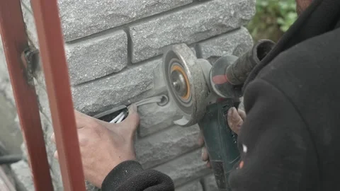 Worker use an Angle Grinder producing. Worker grinding meta Stock Footage 261173370