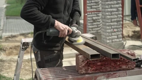 Worker use an Angle Grinder producing. Worker grinding meta Stock Footage 261173377