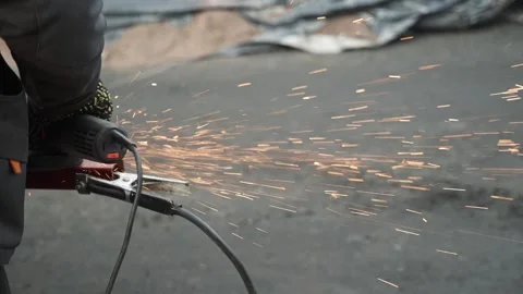Worker use an Angle Grinder producing. Bright sparks and flashes Stock Footage 263801859