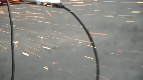 Worker use an Angle Grinder producing. Bright sparks and flashes Stock Footage 263801882