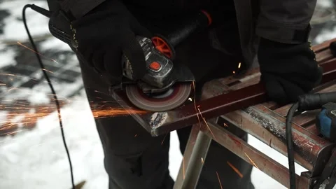 Worker use an Angle Grinder producing. Bright sparks and flashes Stock Footage 263801888