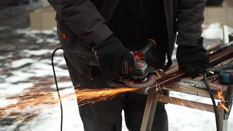 Worker use an Angle Grinder producing. Bright sparks and flashes Stock Footage 263801895