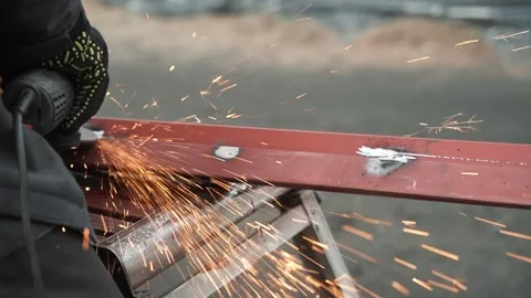 Worker use an Angle Grinder producing. Bright sparks and flashes Stock Footage 263801896