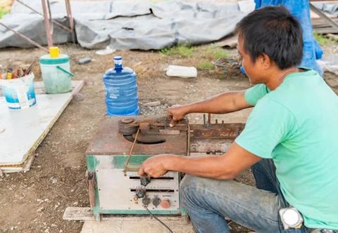 Worker use bending rebar machine for reinforcement. Stock Photos