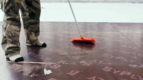 Worker use broomstick to sweep dust on floor of pool Stock Footage 229846273