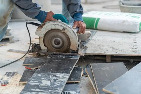 Worker use circular saw cutting plywood. Stock Photos