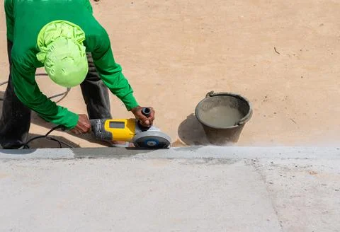 Worker use grinder cut edge mortar in pond. Stock-Fotos