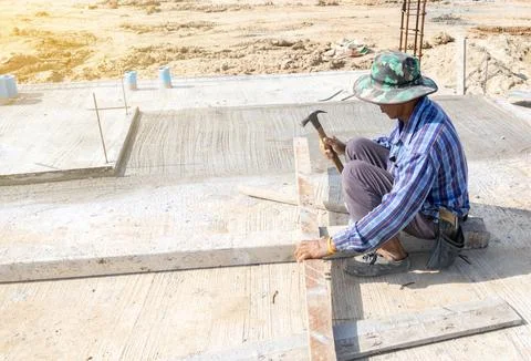 Worker use hammer hit nails on formwork. Stock Photos