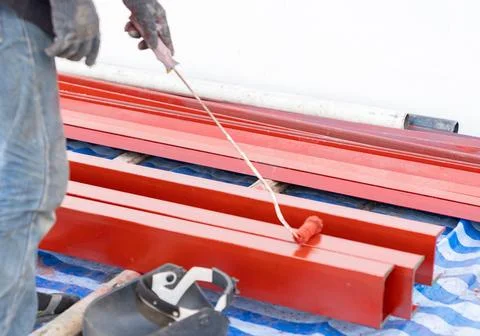 Worker use long brush rustproof paint on long iron Stock Photos