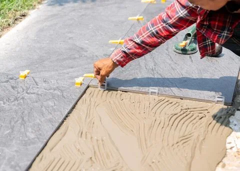 Worker use Plastic clip-on tile leveling on floor. Stock Photos
