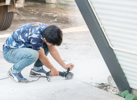 Worker use stone grinding machine cut road floor. Stock Photos