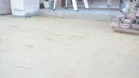 Worker use vibratory plates seals the base sand Stock Footage 98747643