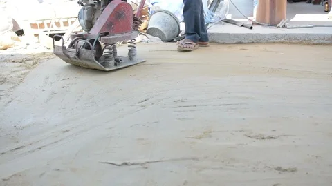 Worker use vibratory plates seals the base sand Stock Footage 98747863