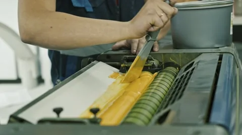Worker use Yellow paint ink roller for printing industry Stock Footage 68385398