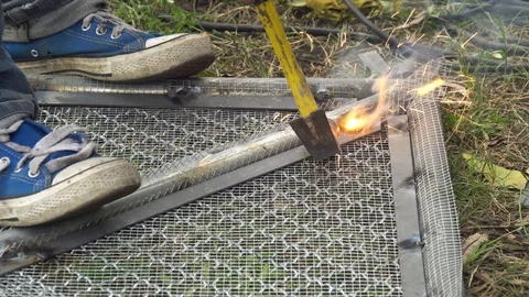 Worker used electric welding wire mesh to make bird cage. 002. 4k Stock Footage 114744850