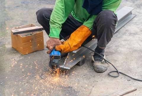 Worker is used Grinding Machine to grinding surface of Beam steel after cut.. Stock Photos