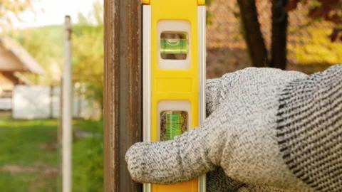 The worker uses building level. Stock Footage 154676198