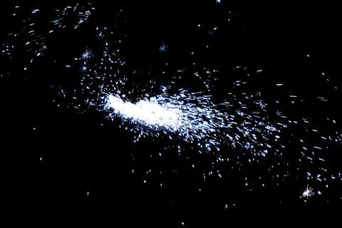 The worker uses a cutting machine to cut metal, focus on flash light line of Stock Photos