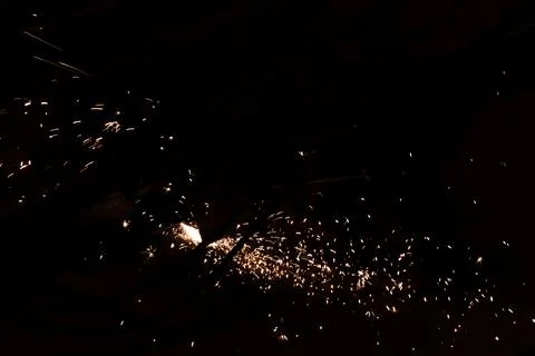 The worker uses a cutting machine to cut metal, focus on flash light line of Stock Photos