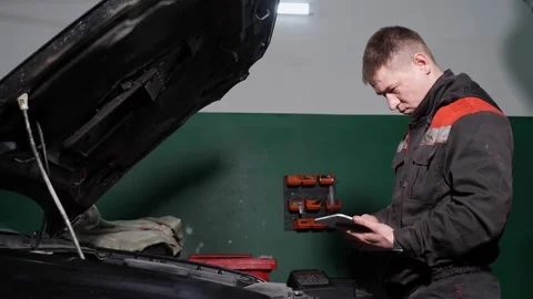 Worker uses digital device to check automobile at station Video stock 150206038