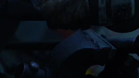 Worker uses electric angle grinder cutting machine on automotive hub Stock Footage 344230998
