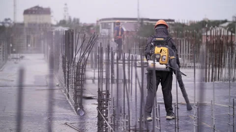 Worker uses a gas Blower to clear construction site Stock Footage 247557702