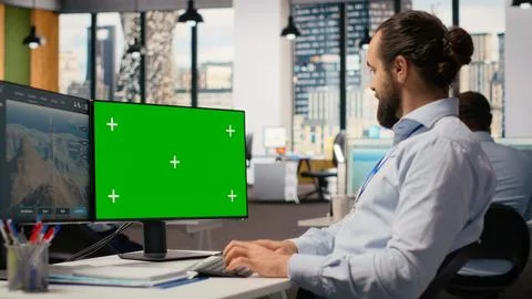 Worker uses green screen mockup PC to optimize advanced VAWT wind farm Stock Photos