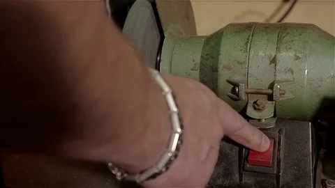 Worker uses grindstone to repair drill in old workshop. Close up view Stock Footage 70897543