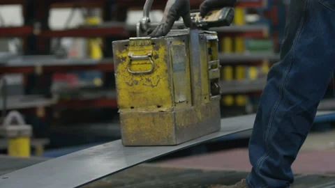 Worker Uses Magnetic Crane Tool to Transport Large Sheet Metal of Steel Stock Footage 136785262