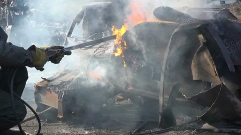 A worker uses a oxygen acetylene cutting torch to cut scrap Stock Footage 103662163