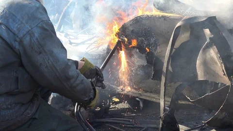 A worker uses a oxygen acetylene cutting torch to cut scrap Stock Footage 103681873