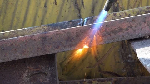 A worker uses a oxygen acetylene cutting torch to cut scrap Stock Footage 104921812
