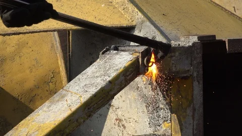 A worker uses a oxygen acetylene cutting torch to cut scrap Stock Footage 104922184