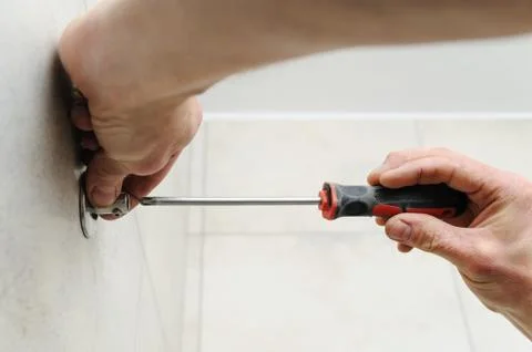 Worker uses a screwdriver. Stock Photos