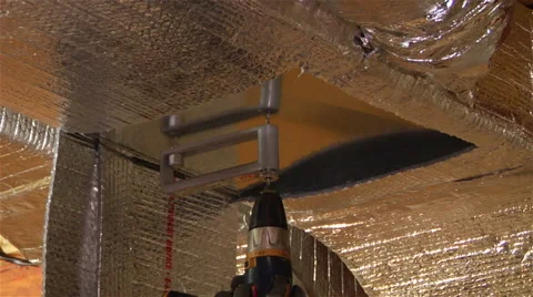 Worker uses specialized drill to cut hole in A/C vent Stock-Footage 42966219