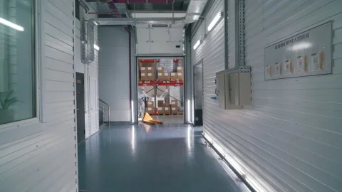 Worker uses a stacker to transport goods in a warehouse Stock Footage 145696470