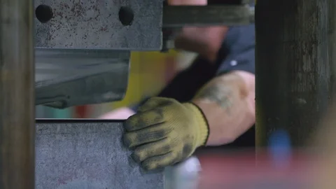 Worker uses Stamping Machine to press sheet metal Closeup Stylized Shot Hands Stock Footage 125178982