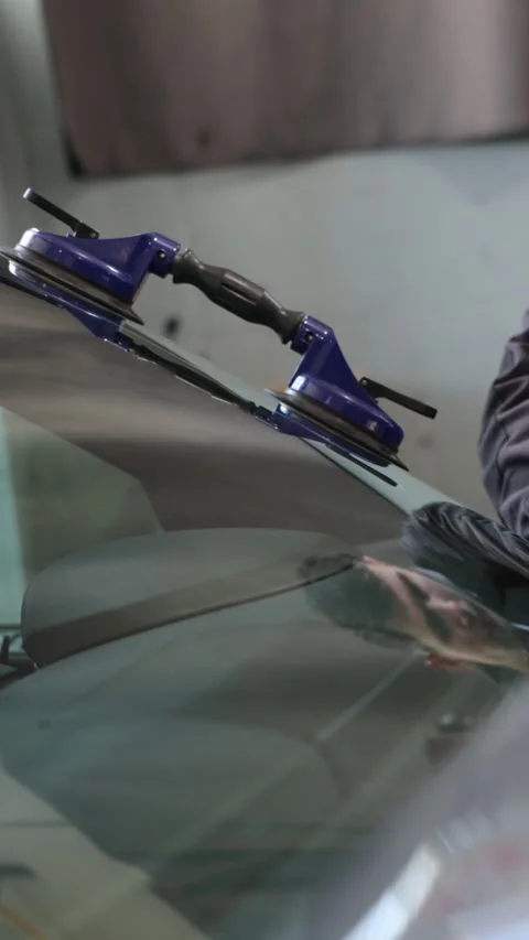 Worker uses tool to remove windshield wiper Stock Footage 335408666